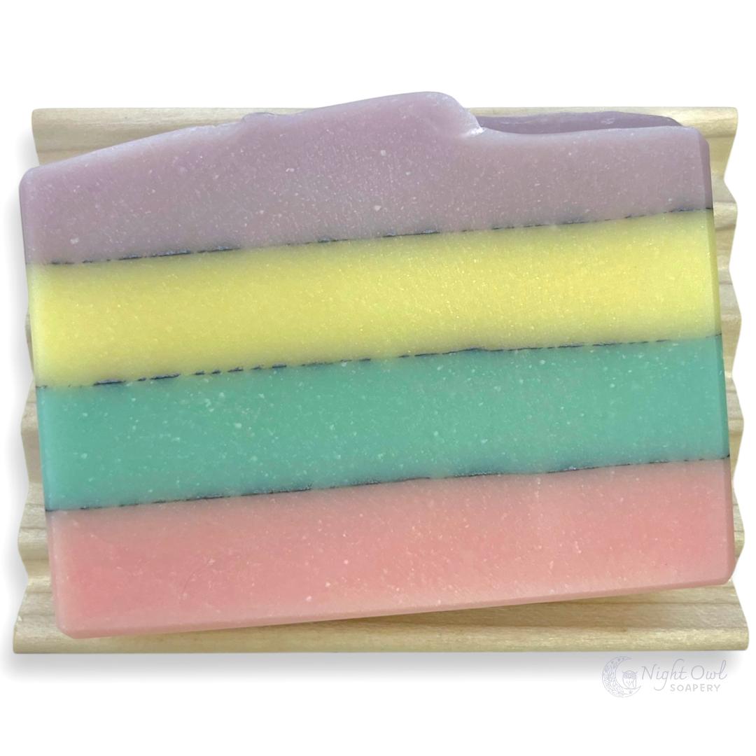 Pastel striped soap on a wooden soap dish