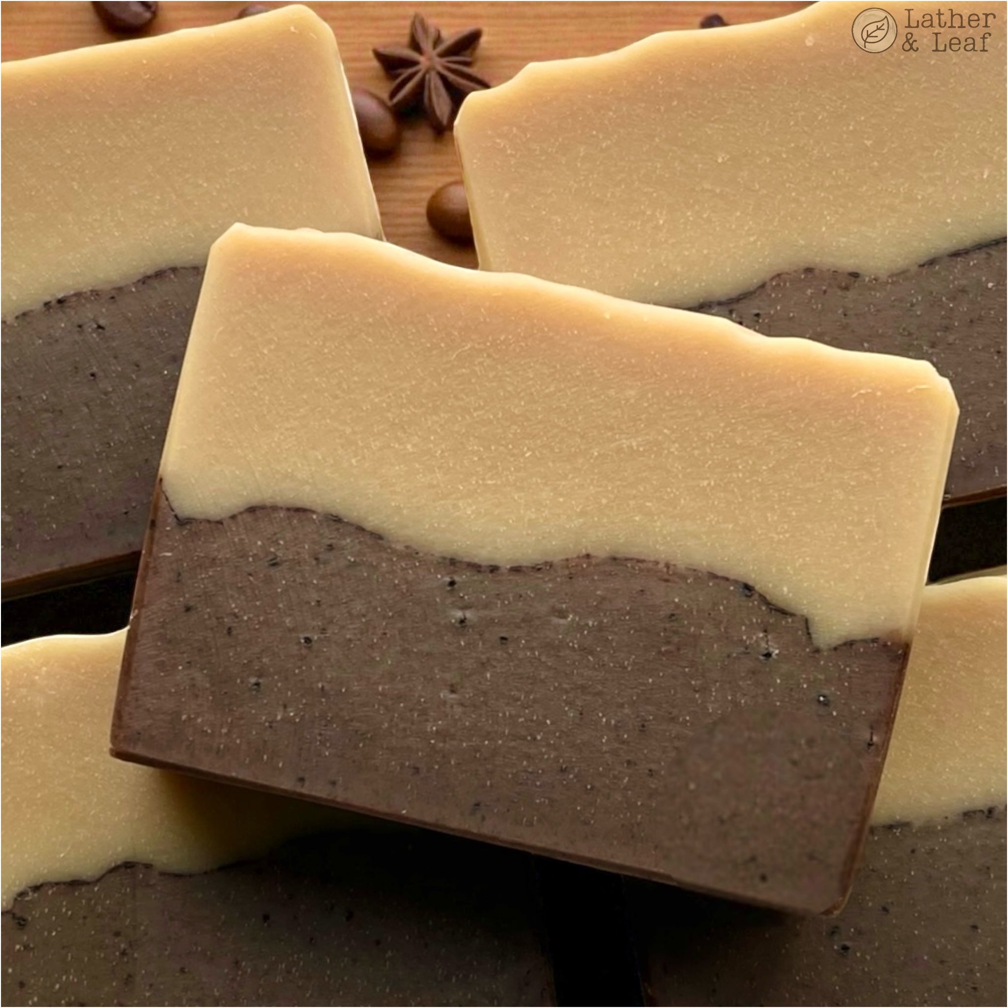 Double layered soap bars with a brown and beige on a wooden surface.
