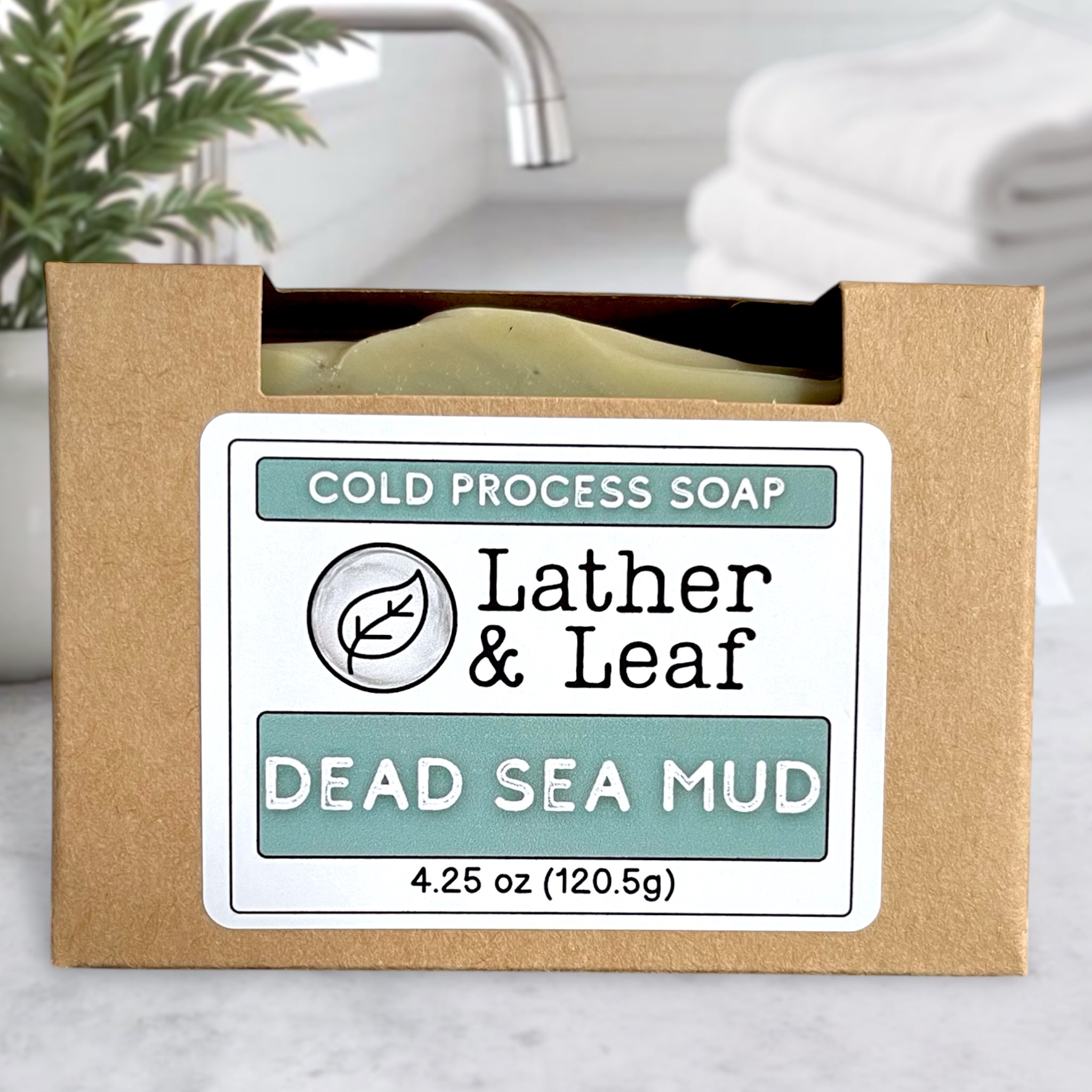 Dead Sea Mud soap bar in a brown box with 'Lather & Leaf' branding.