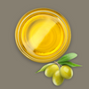 A glass dish of olive oil with green olives on a brown background