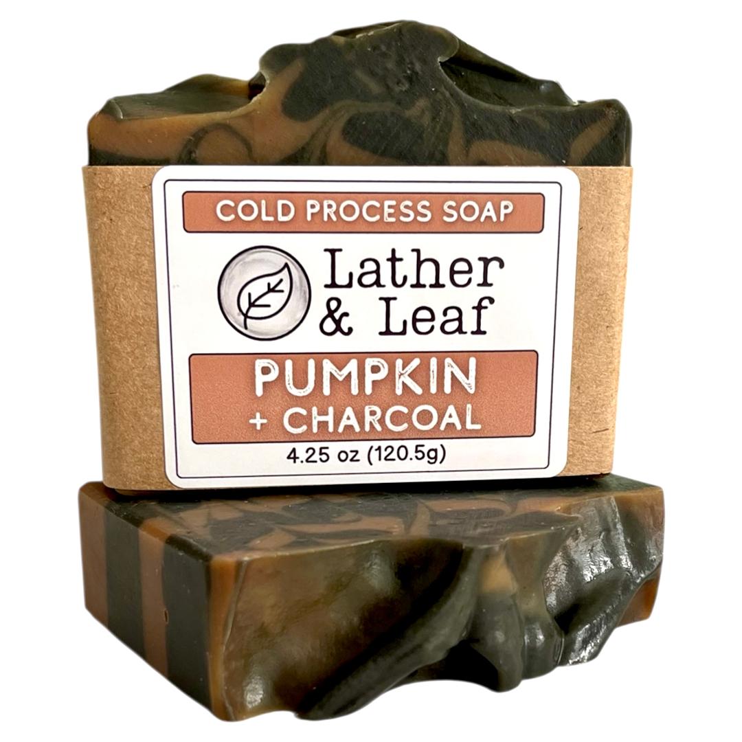 Pumpkin and Charcoalold process soap bar with 'Lather & Leaf' branding on a white background