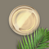 A glass dish of palm oil with palm leaves