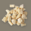Pile of beige sal butter chunks on a gray background
