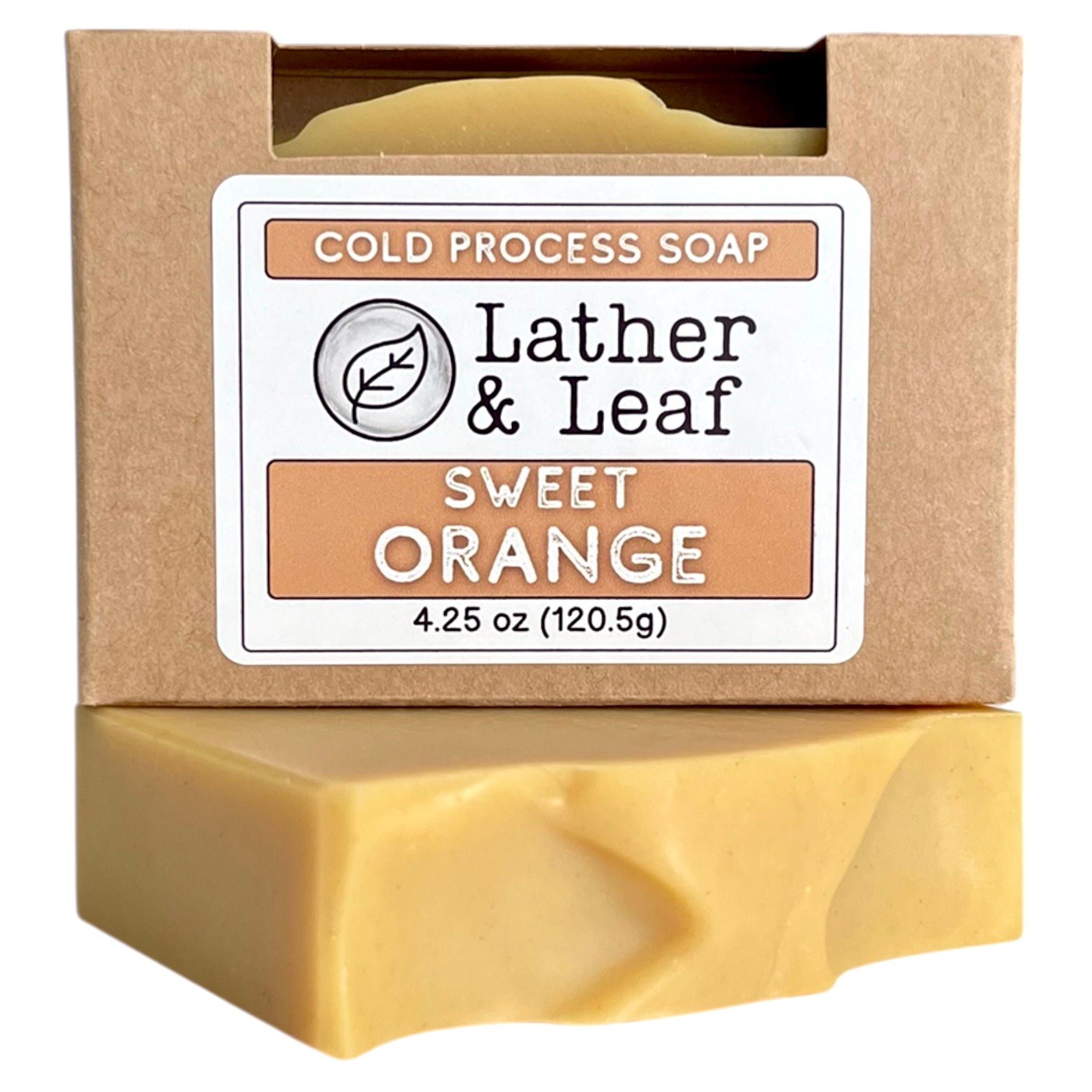 A soap box and bar of sweet orange essential oil soap with 'Lather & Leaf' packaging on a white background