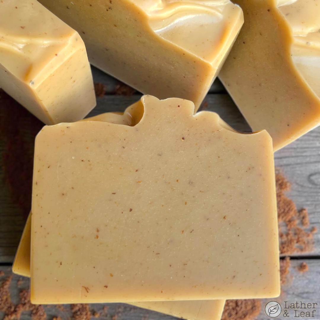 apple cider donut scented soap bars stacked on a table with sprinkled cinnamon 
