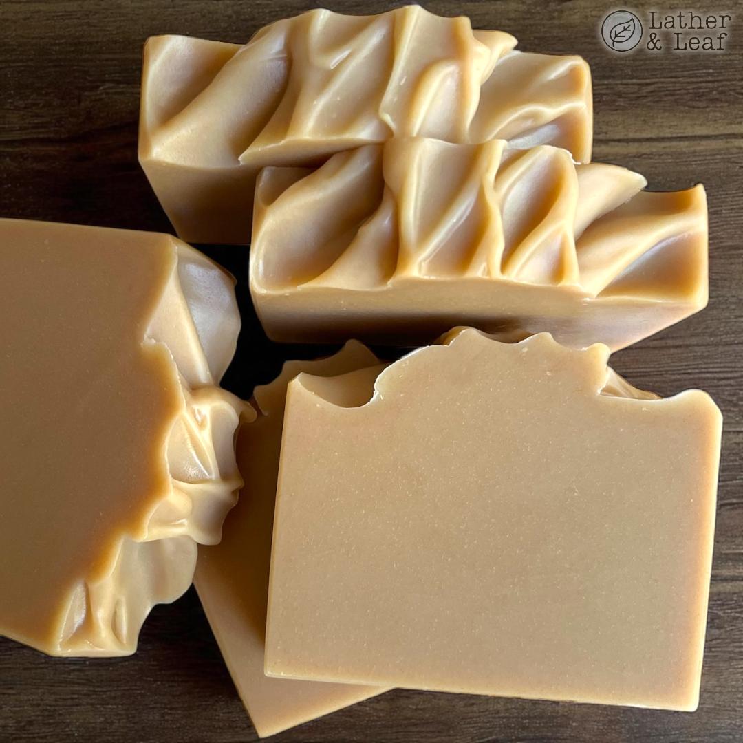triple milk and tallow soap bars neatly arranged on a wooden table
